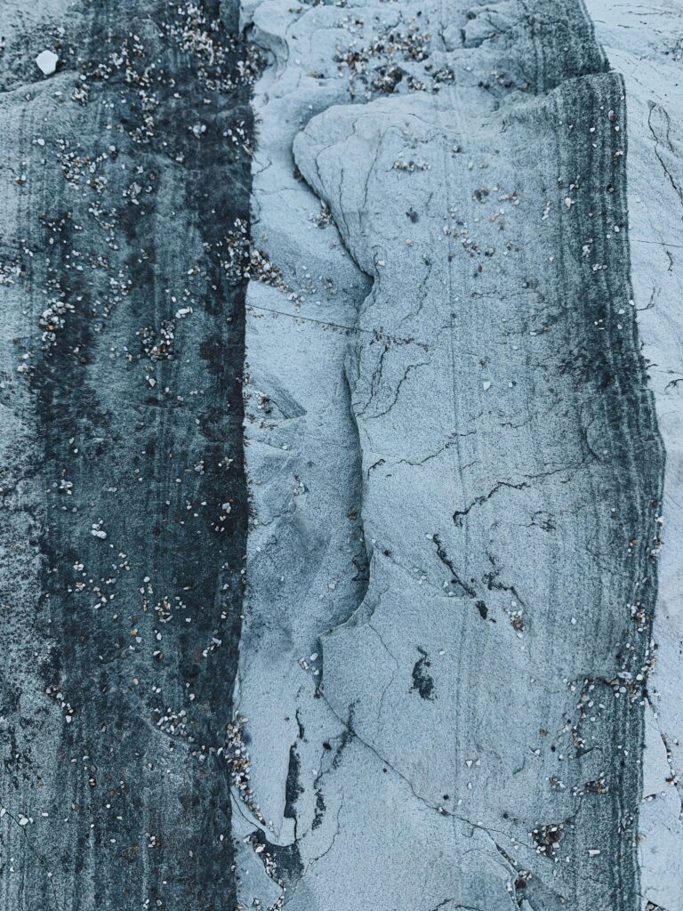 pexels-photo-4951272-4951272 Top view of abstract background of dry uneven rocky surface in blue and white color